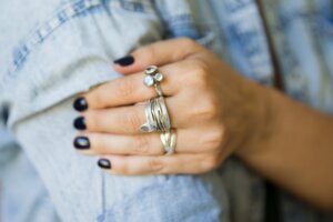 Woman's hand with many silver rings